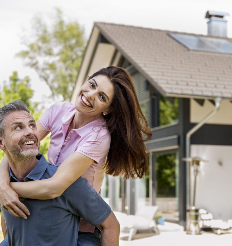 Portrait of happy couple in garden of their home Portrait of happy couple in garden of their home